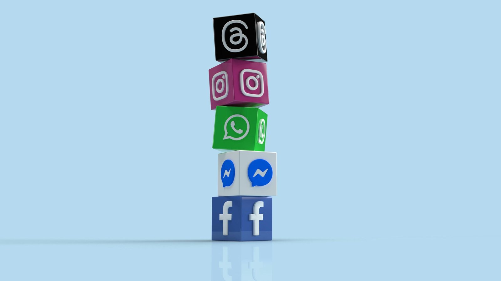 A stack of colorful cubes with social media icons, including Facebook, Messenger, WhatsApp, Instagram and Threads.